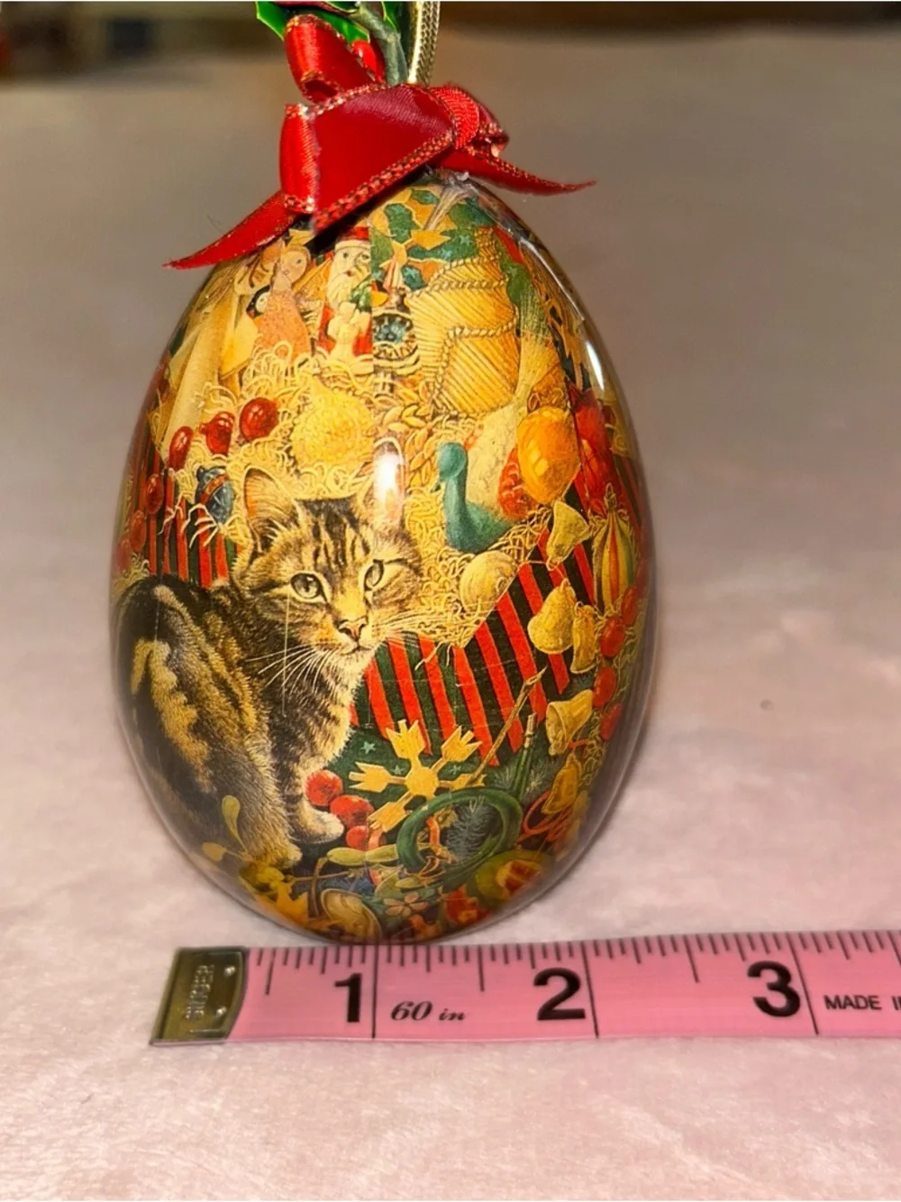 Vintage egg shaped Christmas ornament with cat in festive scene